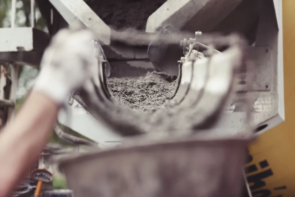 Concrete production using lignosulphonate additives to improve workability and reduce water consumption.