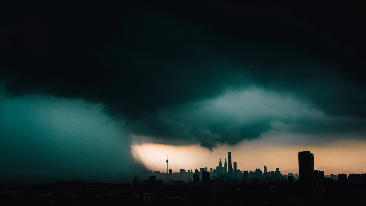 Dark monsoon storm clouds over Kuala Lumpur skyline, showing why waterproofing chemicals are essential in Malaysia's tropical climate